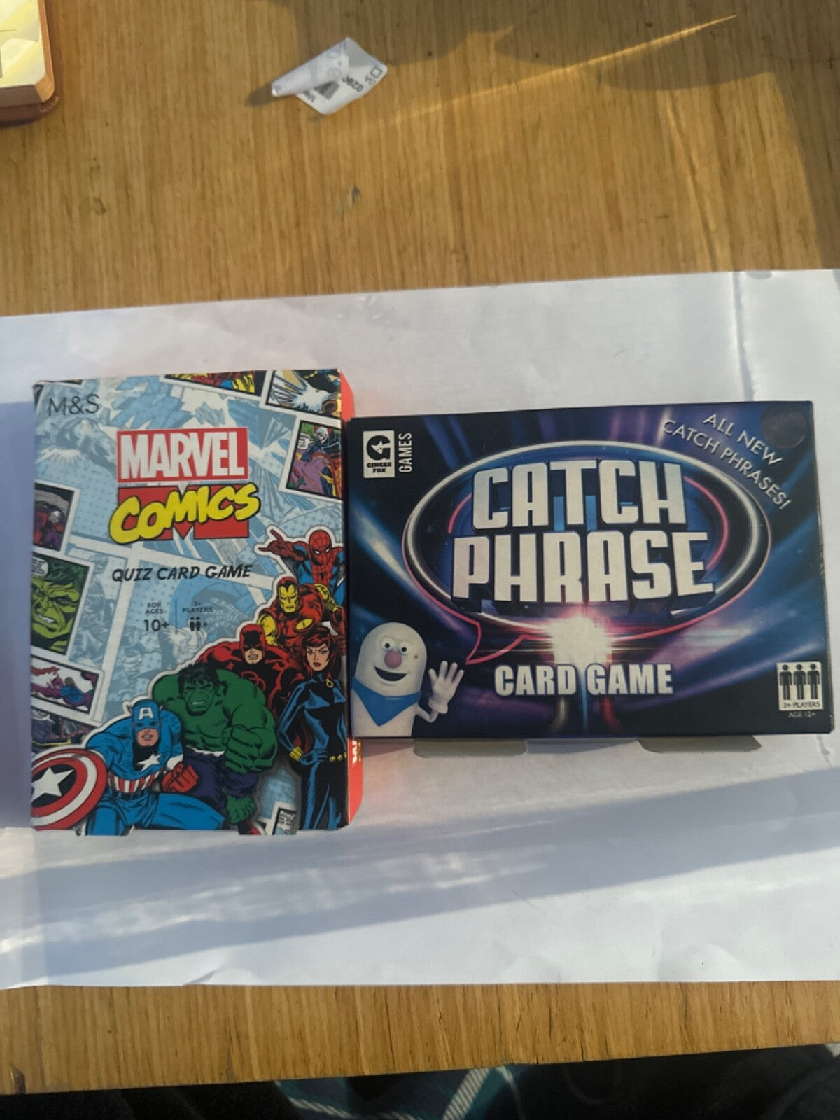 2x Family Card Games. Catchphrase, Marvel Comics Quiz card game